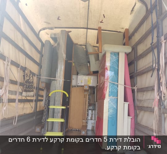 רהיטים וארגזים מסודרים במשאית הובלה
